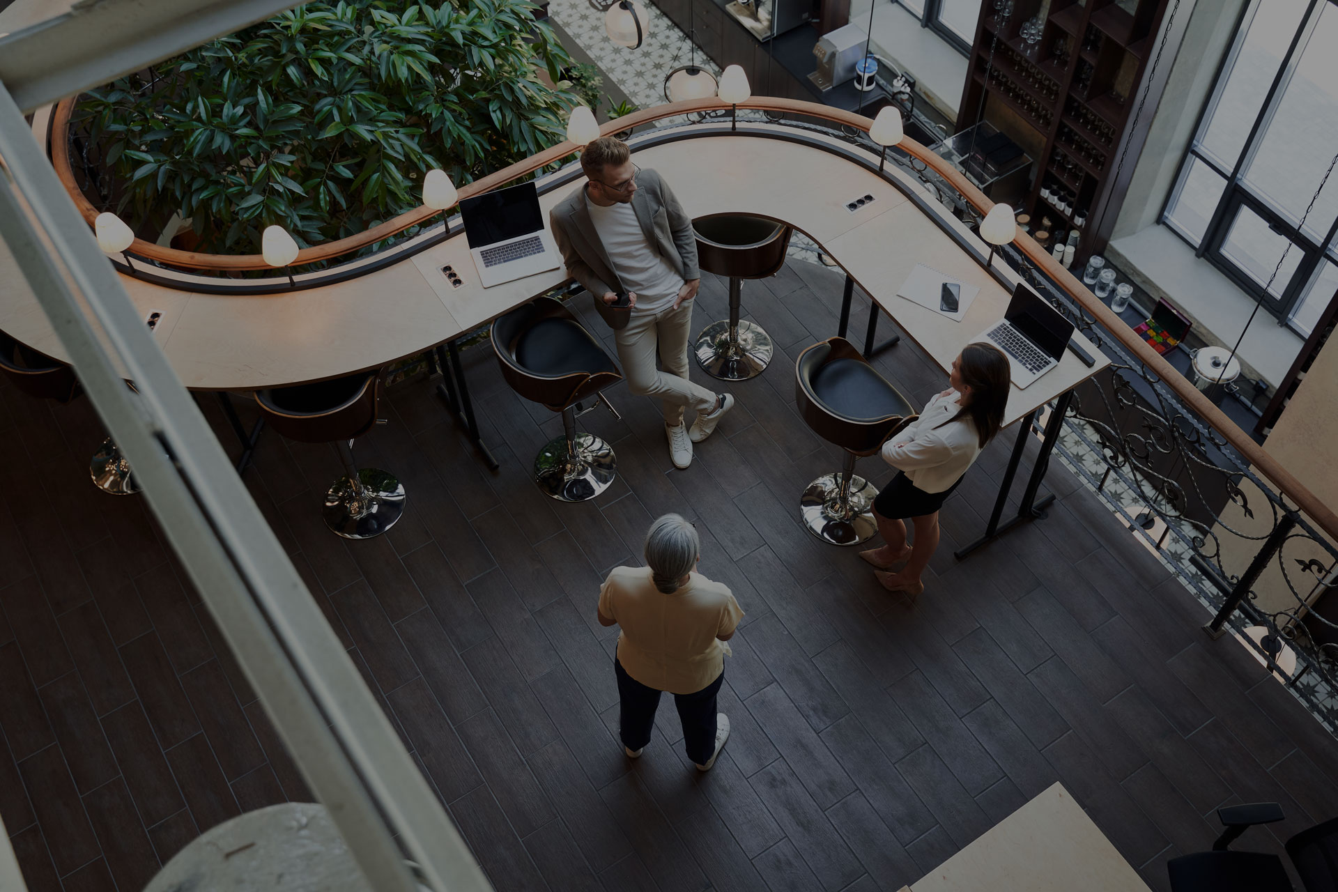 Overhead shot of office workers talking to one another in a modern office