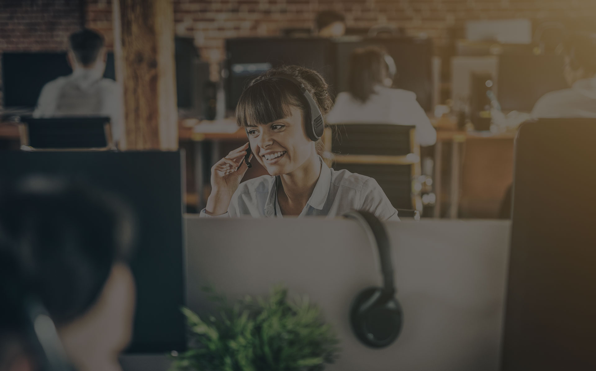 A women working in a call center talking into her headset