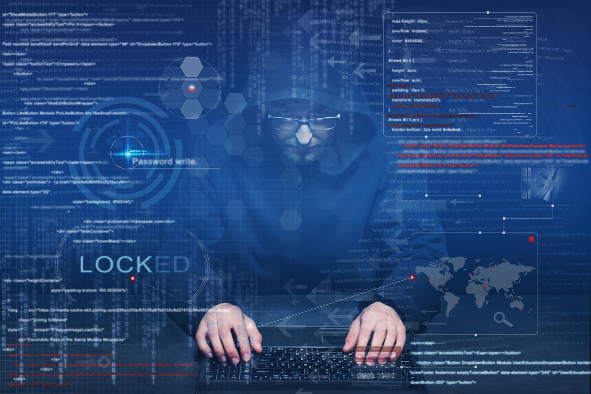 A hooded figure typing at a laptop behind a blue overlay of binary code, a world map, and the word LOCKED.