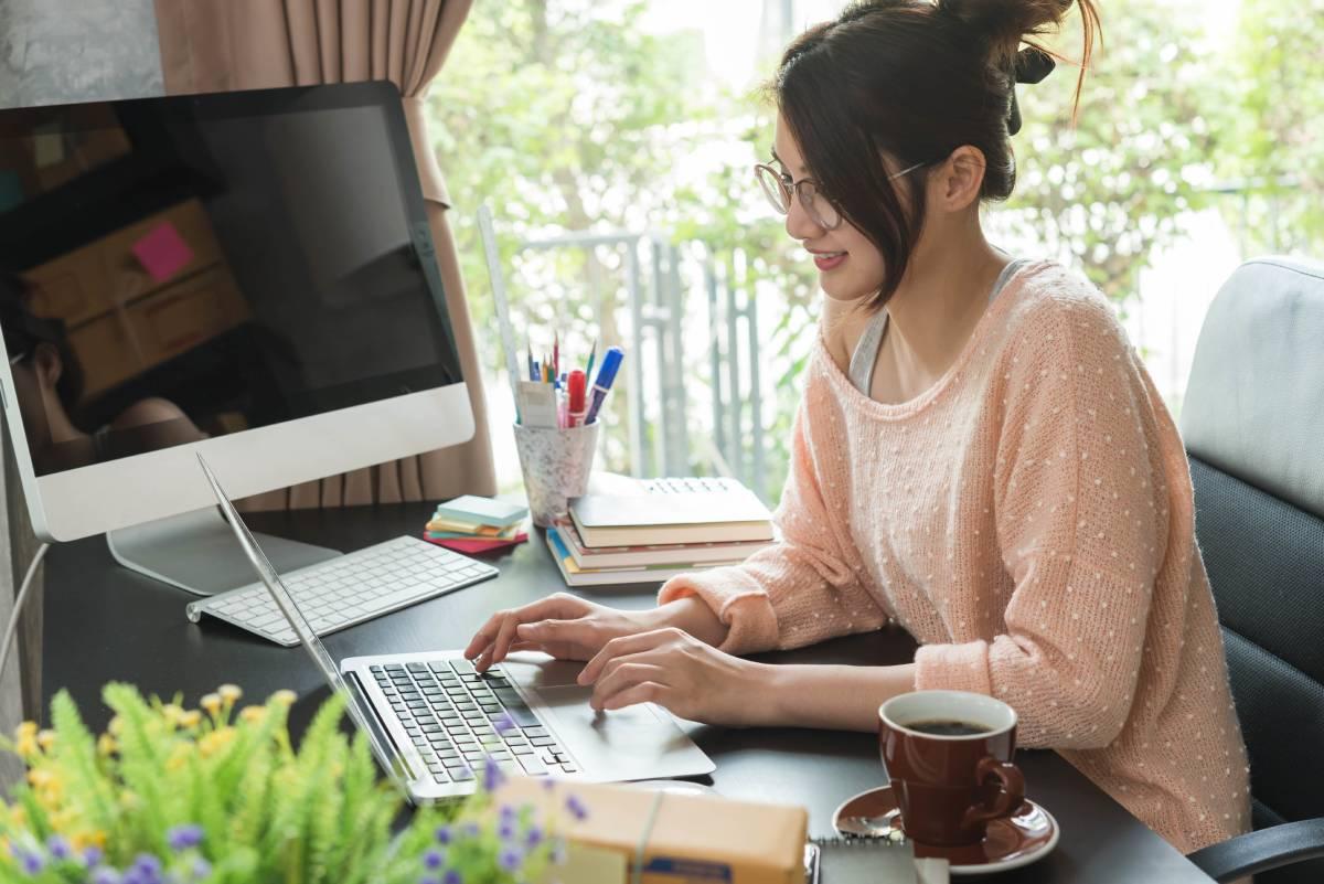 Smiling woman working on computer