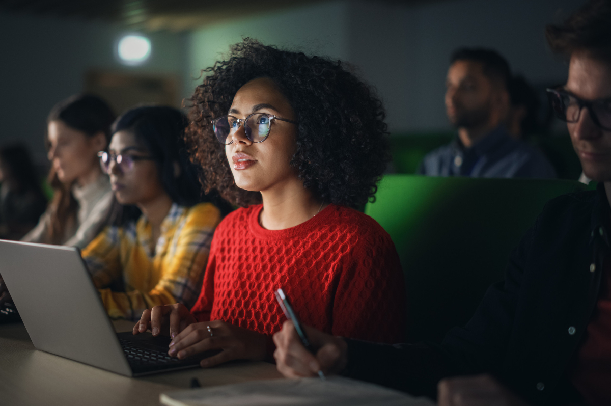 Female student learning with a laptop in a classroom